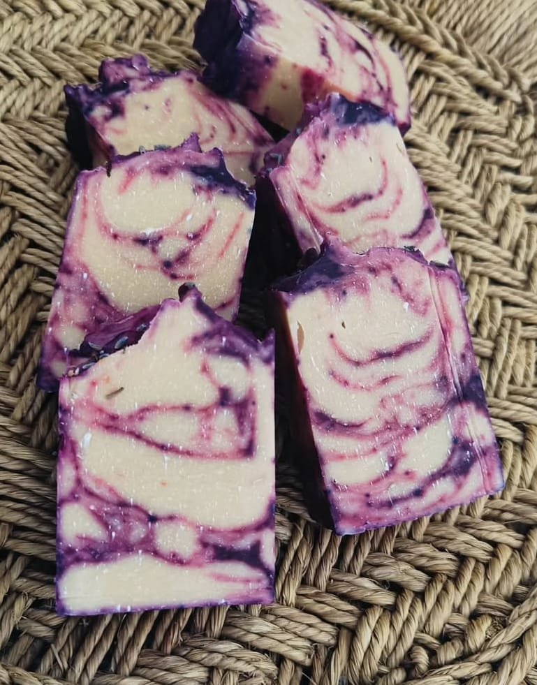 Purple and cream lavender-swirl cold process soap bars on a woven basket, from the 24-Hr Faster Curing Cold Process Soap Workshop